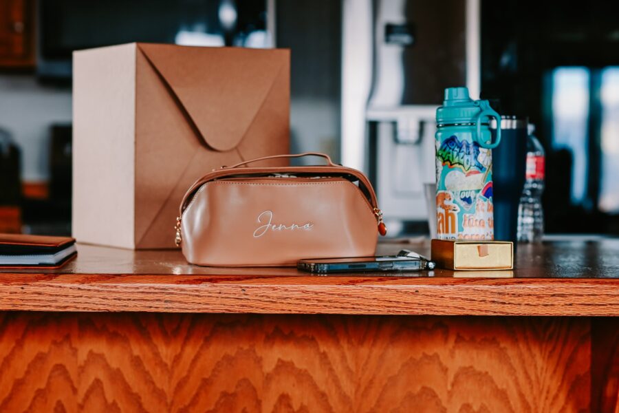 A stylish beige cosmetic bag with the name 